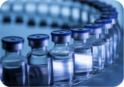 line of vaccine vials on factory conveyor belt